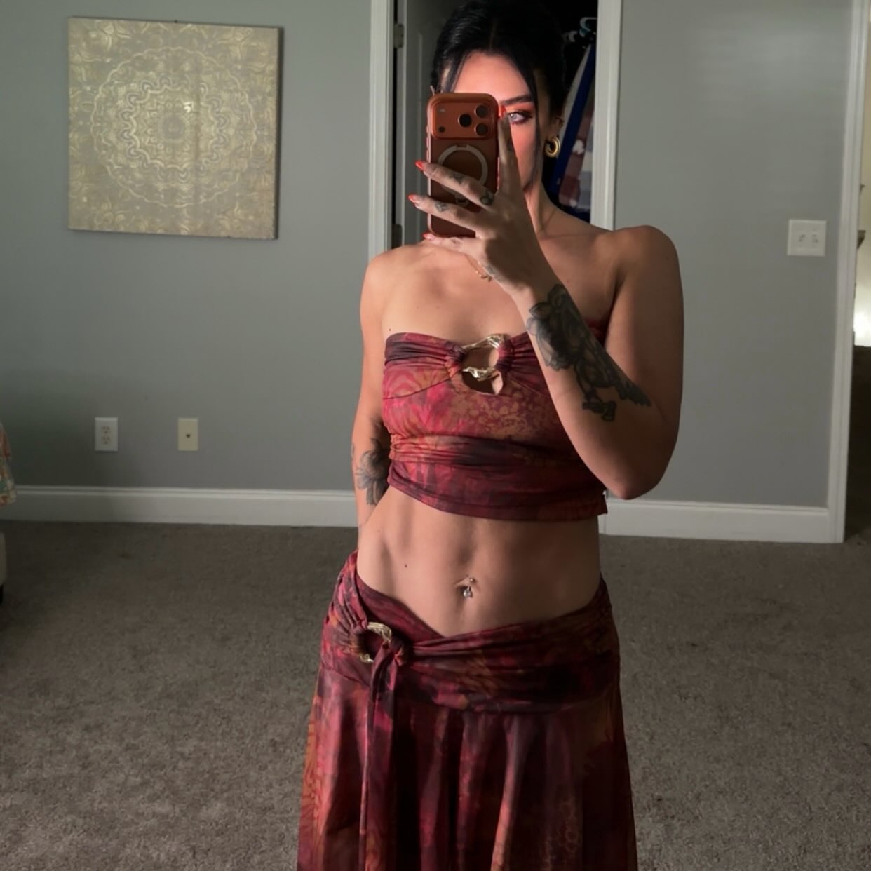 Ally in a red patterned two-piece outfit